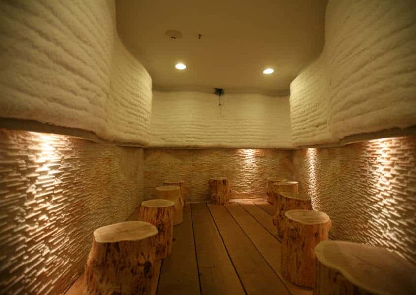 a room with benches made out of logs.