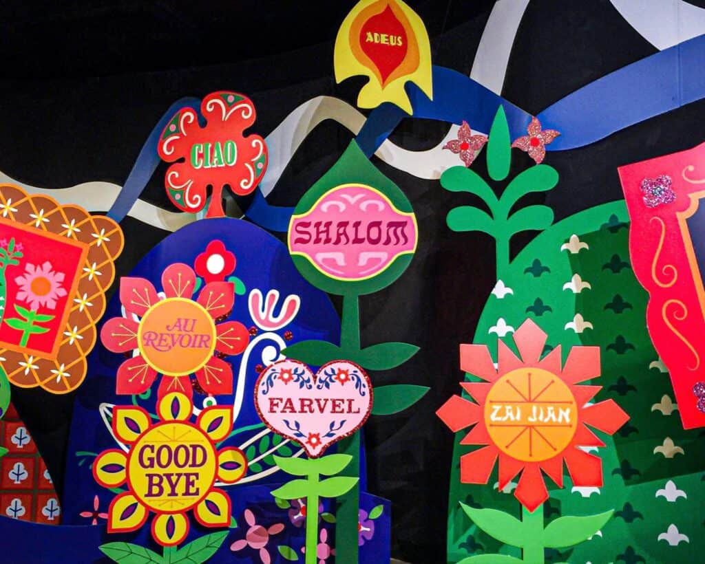 a bunch of colorful paper cut outs on a wall.
