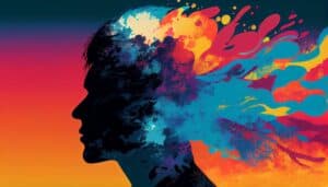 Silhouette of a person's head with colorful, abstract paint splashes emanating from the back against a gradient orange and blue background.